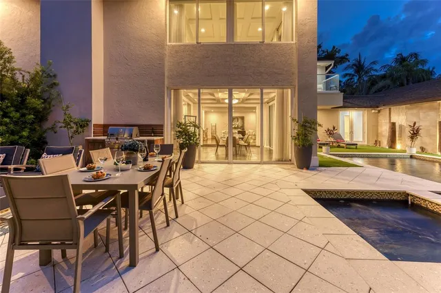 a view of a patio with couches and a table and chairs with potted plants