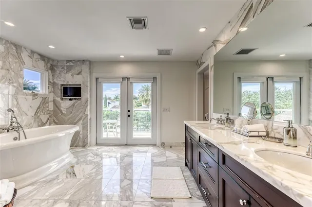 a large bathroom with a large tub and sink
