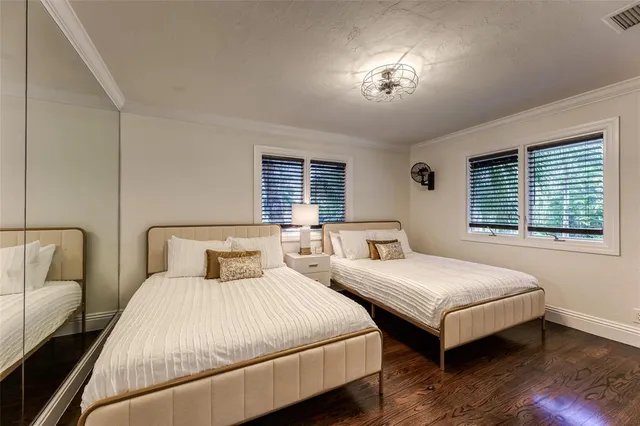 a bedroom with two beds and a chandelier