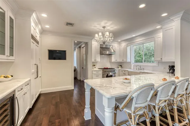 a view of a dining room with furniture a chandelier and wooden floor