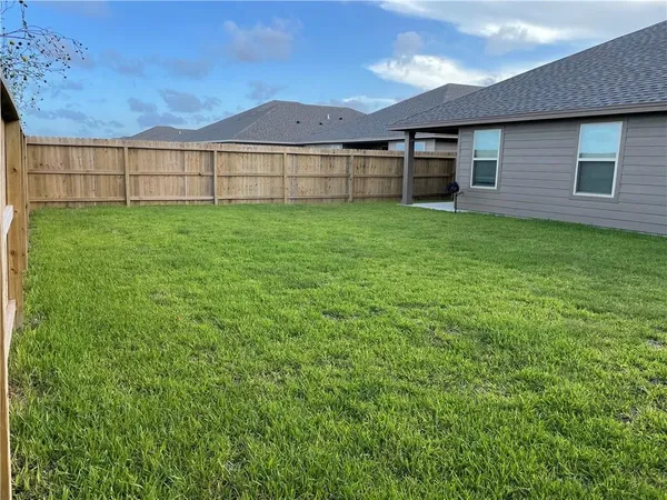 a view of a house with a yard and sitting area