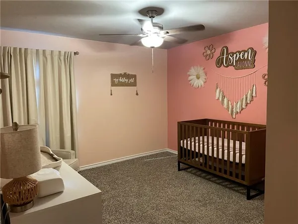 a view of a room with furniture and a chandelier fan