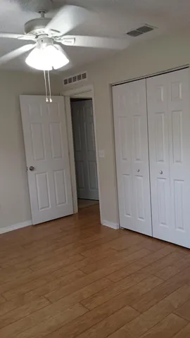 a view of an empty room with a fan