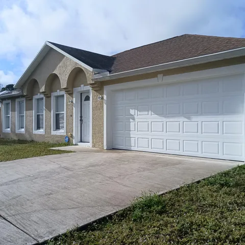 a view of a house with a yard and garage
