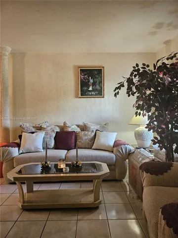 a living room with furniture and flowers