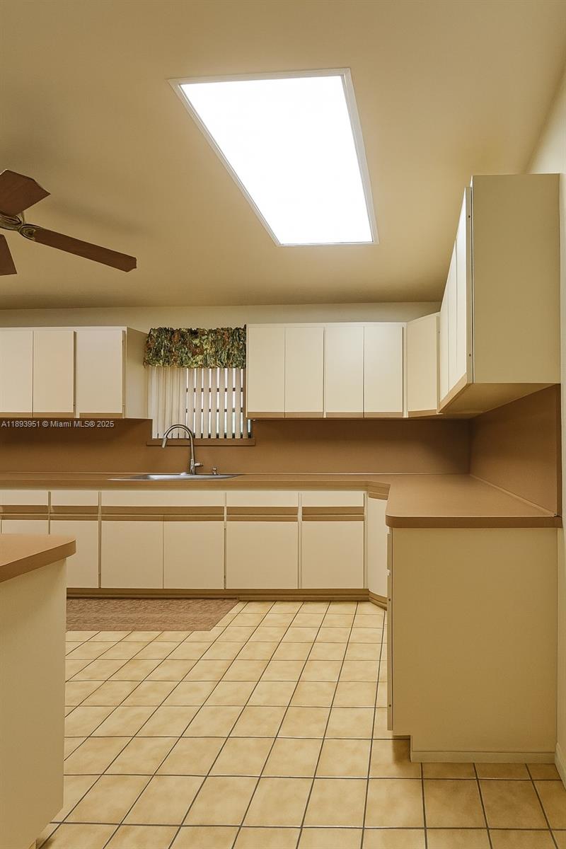 6240 Southwest 20th Terrace Miami, FL 33155 - Photo 14 of 30 a kitchen with stainless steel appliances a sink and a stove