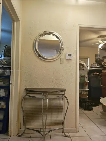 a bathroom with a granite countertop shower a mirror and a sink