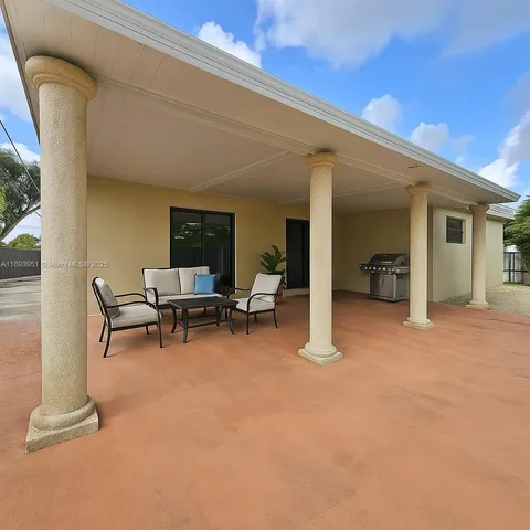 a view of a patio with table and chairs