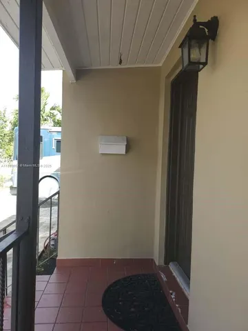 a view of entryway with a window and wooden floor
