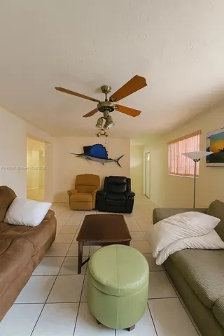 a bedroom with two beds and a chandelier