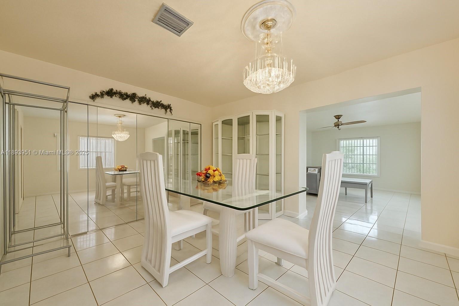 6240 Southwest 20th Terrace Miami, FL 33155 - Photo 10 of 30 a room with lots of white furniture and glass door