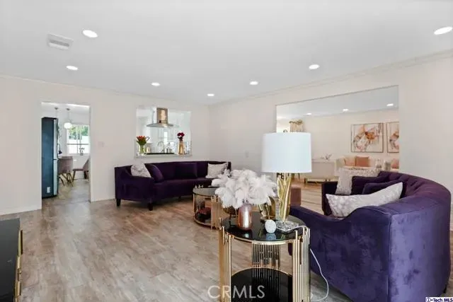 a living room with furniture and wooden floor