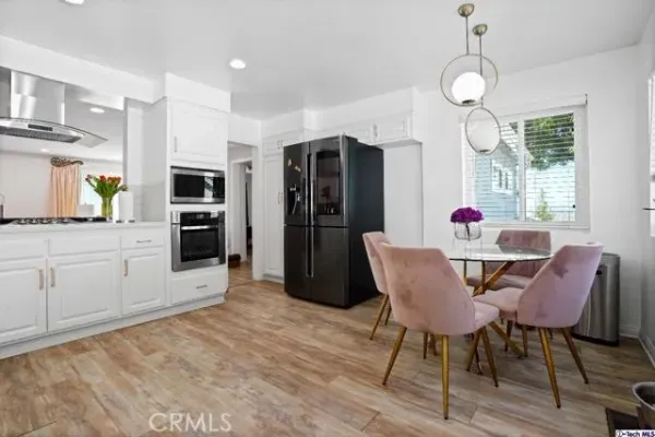a view of a dining room with furniture and wooden floor