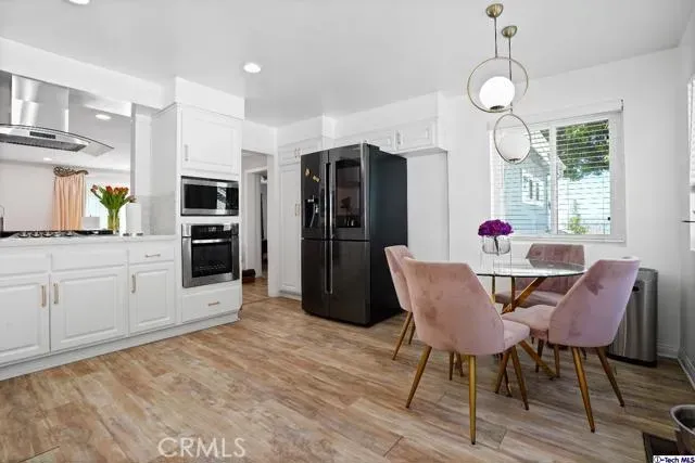 a view of a dining room with furniture and wooden floor