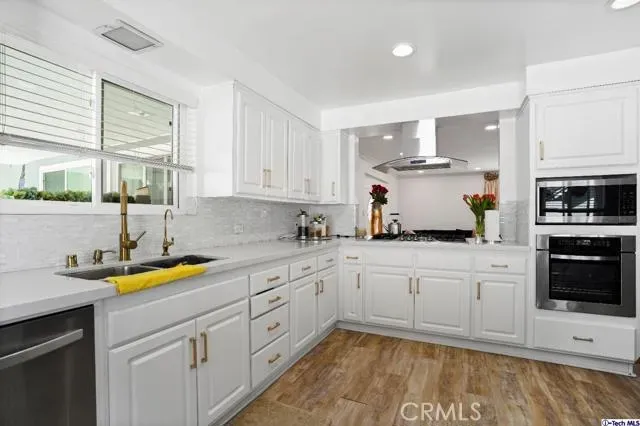 a kitchen with a sink white cabinets and white appliances