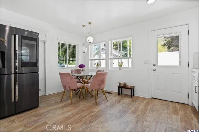 a dining room with furniture a chandelier and wooden floor