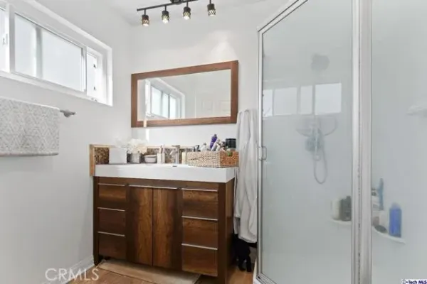 a bathroom with a granite countertop sink mirror and