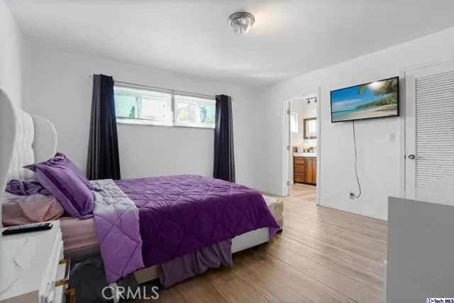 a bedroom with a bed and a window