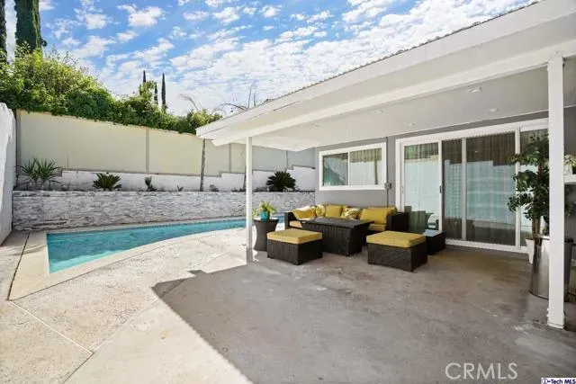 a view of a house with backyard and sitting area