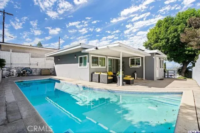 a view of a house with backyard porch and sitting area