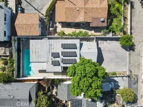 an aerial view of multiple houses with yard