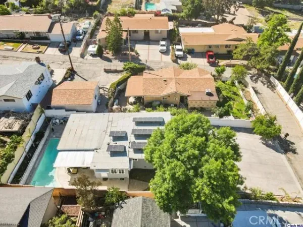 an aerial view of a house with a yard