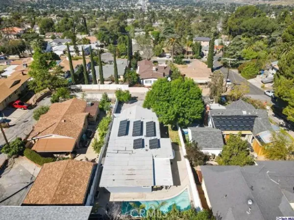 an aerial view of residential houses with outdoor space