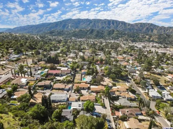 an aerial view of residential houses with outdoor space