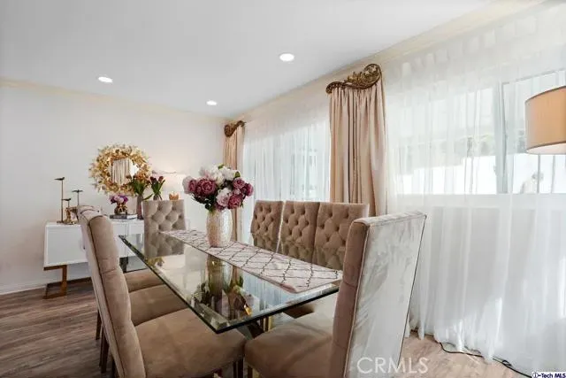 a view of a dining room with furniture and wooden floor