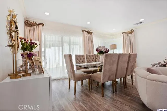 a view of a dining room with furniture and a floor to ceiling window