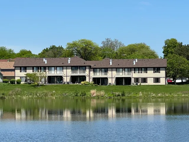 a front view of a house with a lake yard