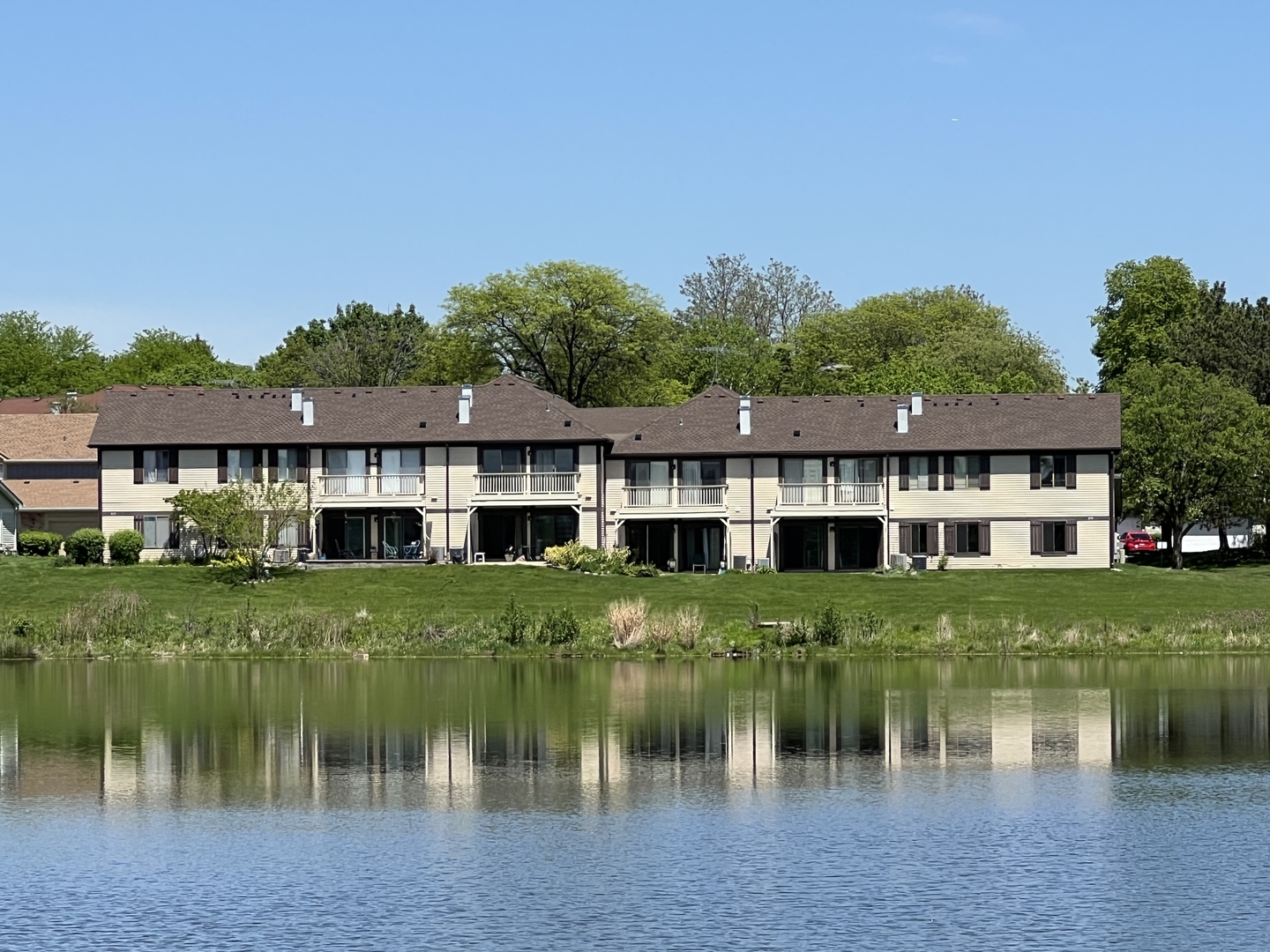 370 Springlake Lane, Unit B Aurora, IL 60504 - Photo 16 of 26 a front view of a house with a lake yard