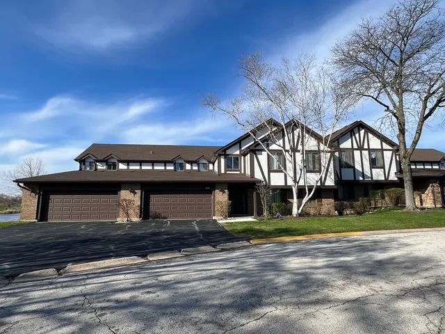 a front view of a building with a garden