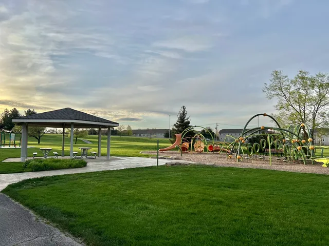 a view of a park with swings and slides