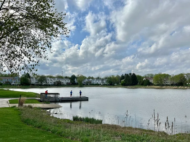 a view of lake with table and chairs