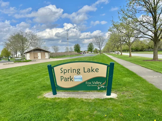 a sign that is sitting on the grass of the house