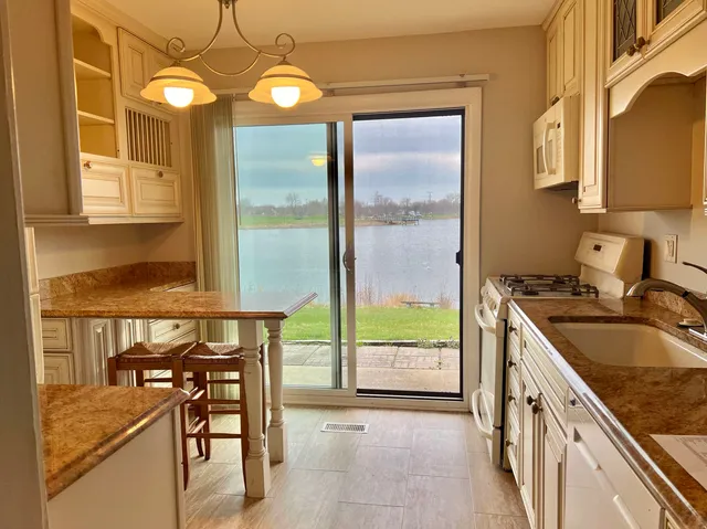 a kitchen with a table chairs stove and sink