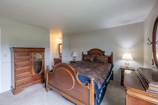 a bedroom with a bed and a mirror