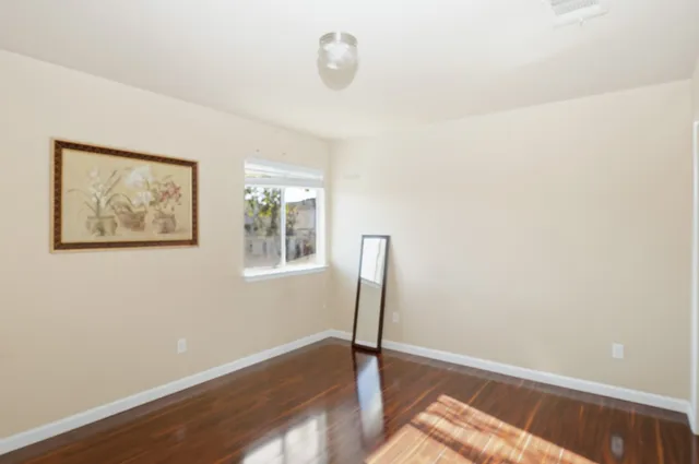 a view of a room with wooden floor and window