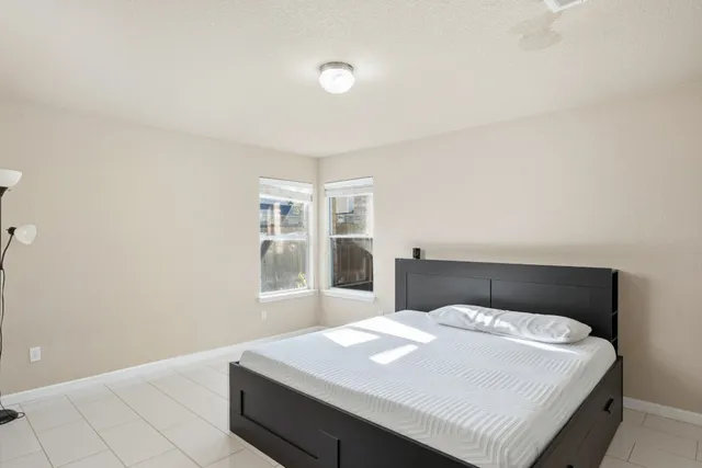 a bedroom with a bed and a window