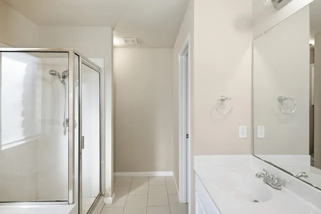 a bathroom with a sink and shower