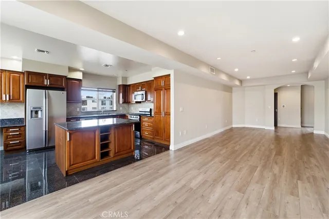 a kitchen with stainless steel appliances a refrigerator and a stove