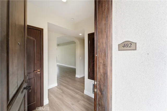 a view of hallway with wooden floor