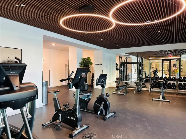 a view of a swimming pool with tables and chairs under an umbrella
