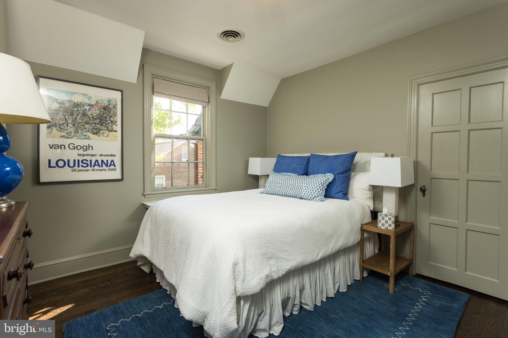 7005 Copeleigh Road Baltimore, MD 21212 - Photo 35 of 51 a bedroom with a bed and wooden floor