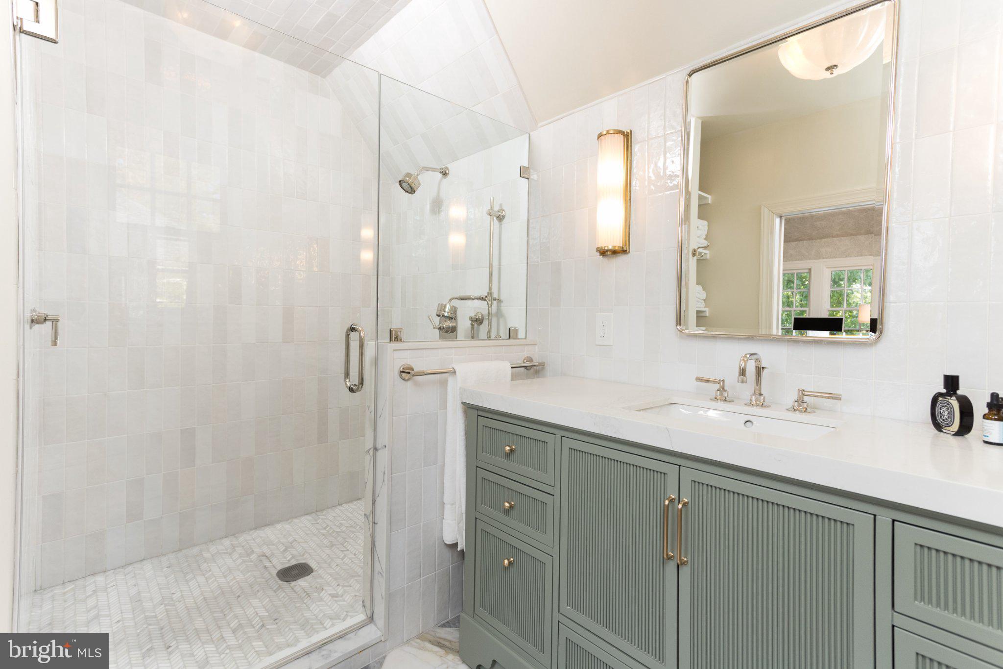 7005 Copeleigh Road Baltimore, MD 21212 - Photo 39 of 51 a bathroom with a shower sink and mirror