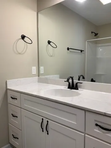 a bathroom with a double vanity sink and a mirror