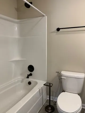 a bathroom with a toilet and a tub