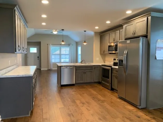 a kitchen with stainless steel appliances a refrigerator and a sink
