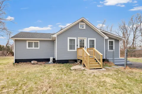 a view of a house with wooden fence